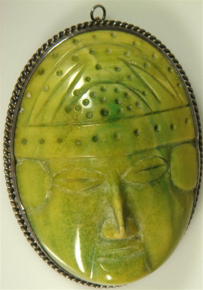 Appraisal: Carved green stone face pin in silver setting Mexican South