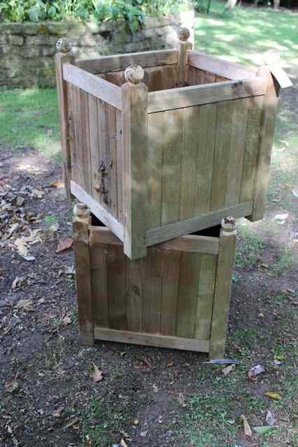 Appraisal: A PAIR OF TEAK CUBIC PLANTERS with ball finials each