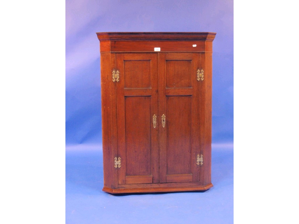 Appraisal: A Georgian oak and mahogany hanging corner cupboard with two