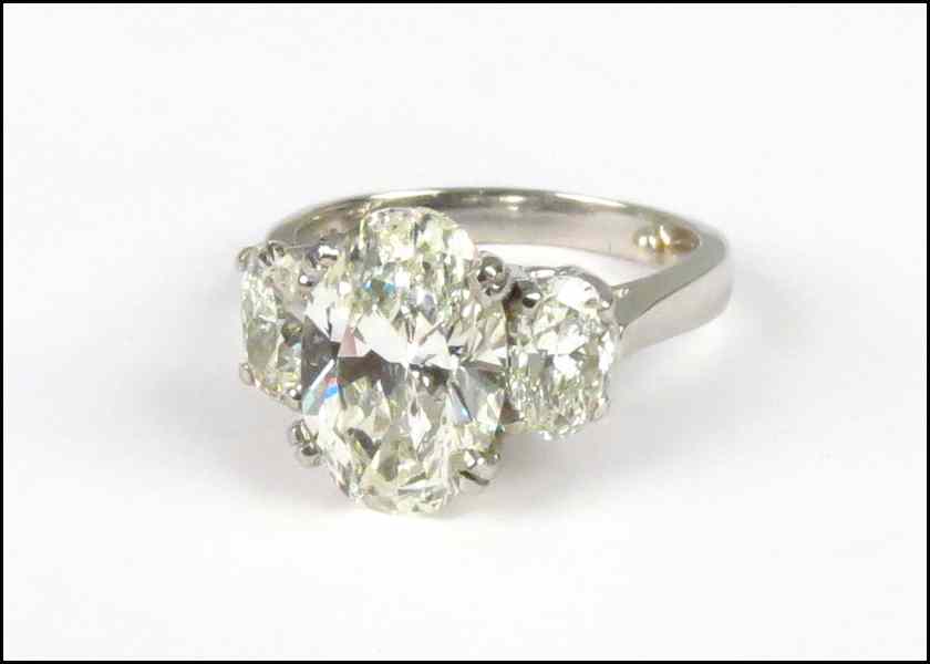 Appraisal: DIAMOND AND PLATINUM RING Central oval diamond is SI clarity