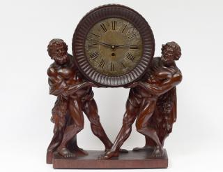 Appraisal: CARVED WALNUT FIGURAL MANTEL CLOCK European th Century The case