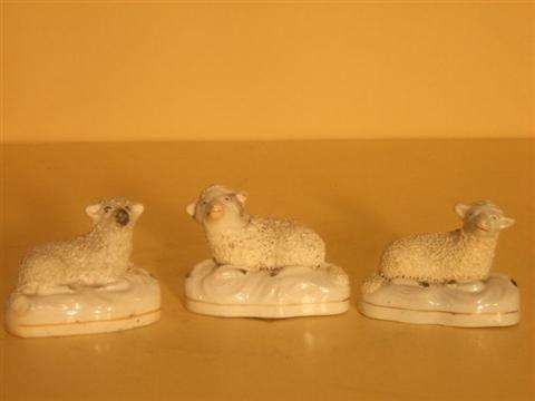 Appraisal: THREE STAFFORDSHIRE MODELS OF SHEEP Including a ram and ewe