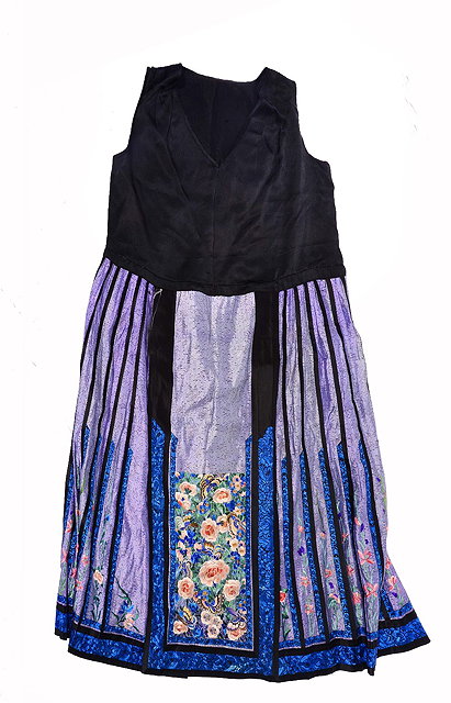 Appraisal: A CHINESE BLACK AND PURPLE SILK DRESS with embroidered foliate