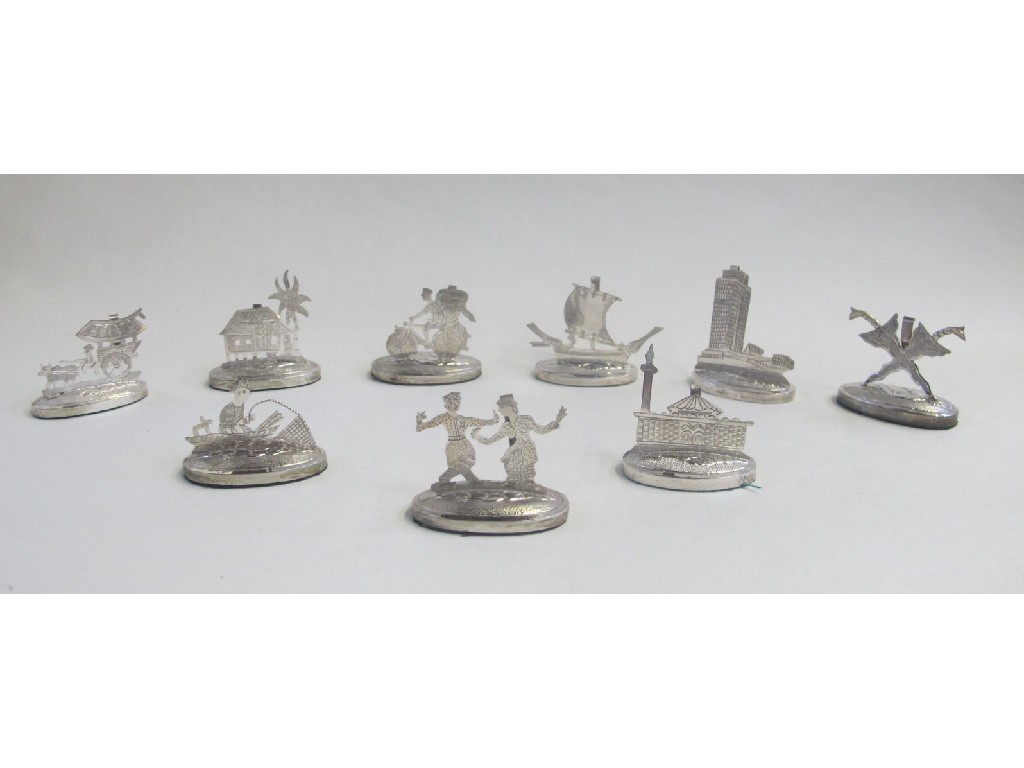 Appraisal: Set of nine Eastern white metal menu holders modelled as