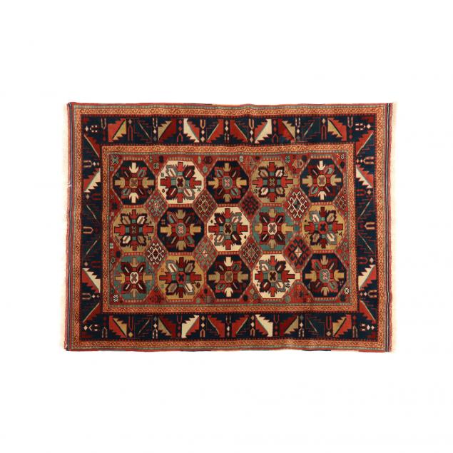 Appraisal: CAUCASIAN STYLE AREA RUG Orange field with repeating medallions blue