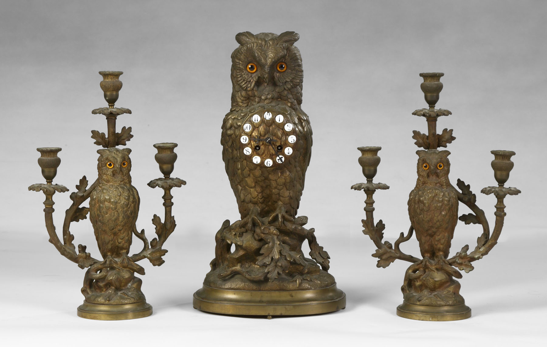 Appraisal: Piece Bronze Owl Clock Set Clock features porcelain numbers on