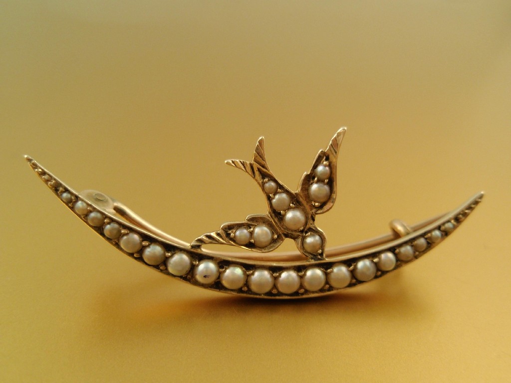 Appraisal: A Victorian seed pearl set brooch of crescent with bird