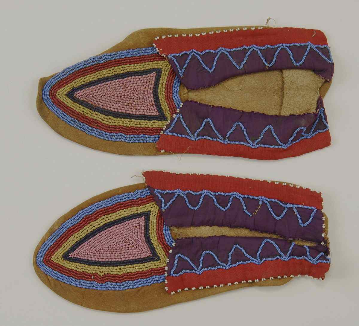 Appraisal: PAIR OF BEADWORK MOCCASINSEarly th CenturyWith pink black yellow red