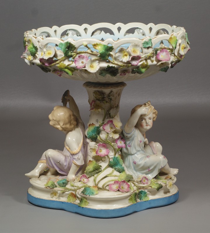 Appraisal: Continental Porcelain Figural Based Centerpiece one figure with a seashell