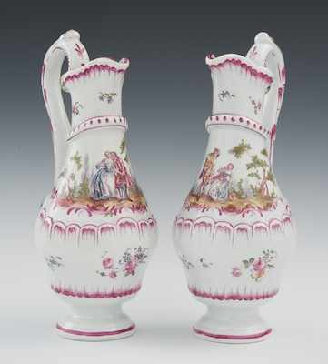 Appraisal: A Pair of Hand Decorated Faience Ewers The delicately proportioned