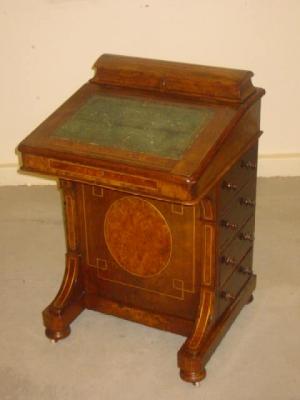 Appraisal: A VICTORIAN WALNUT DAVENPORT with stringing and inlaid burr walnut