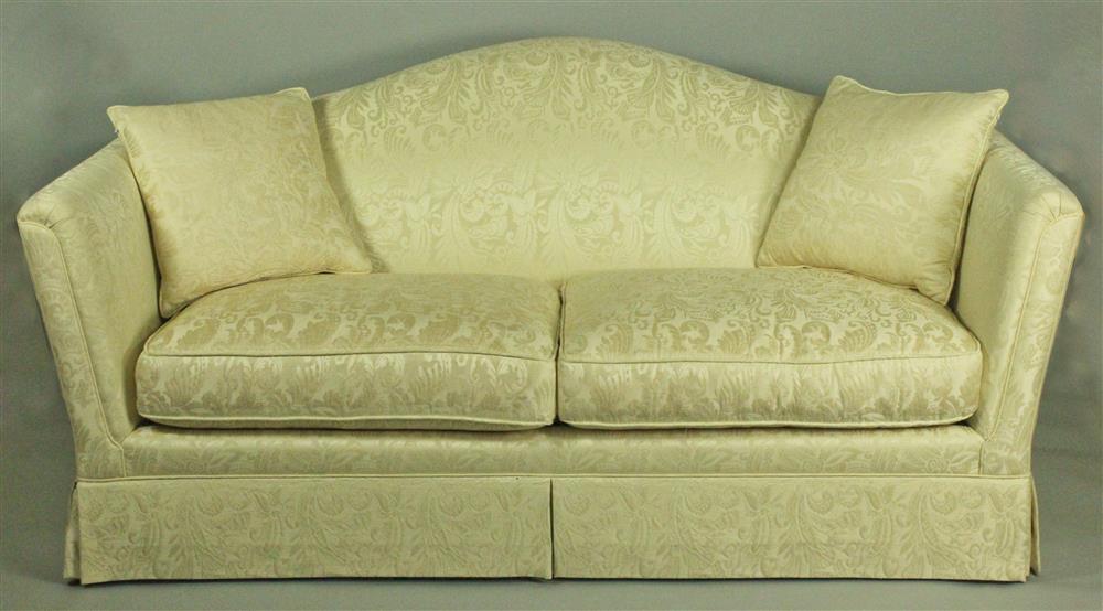 Appraisal: NANCY CORZINE CREAM DAMASK UPHOLSTERED SOFA the arched tight back