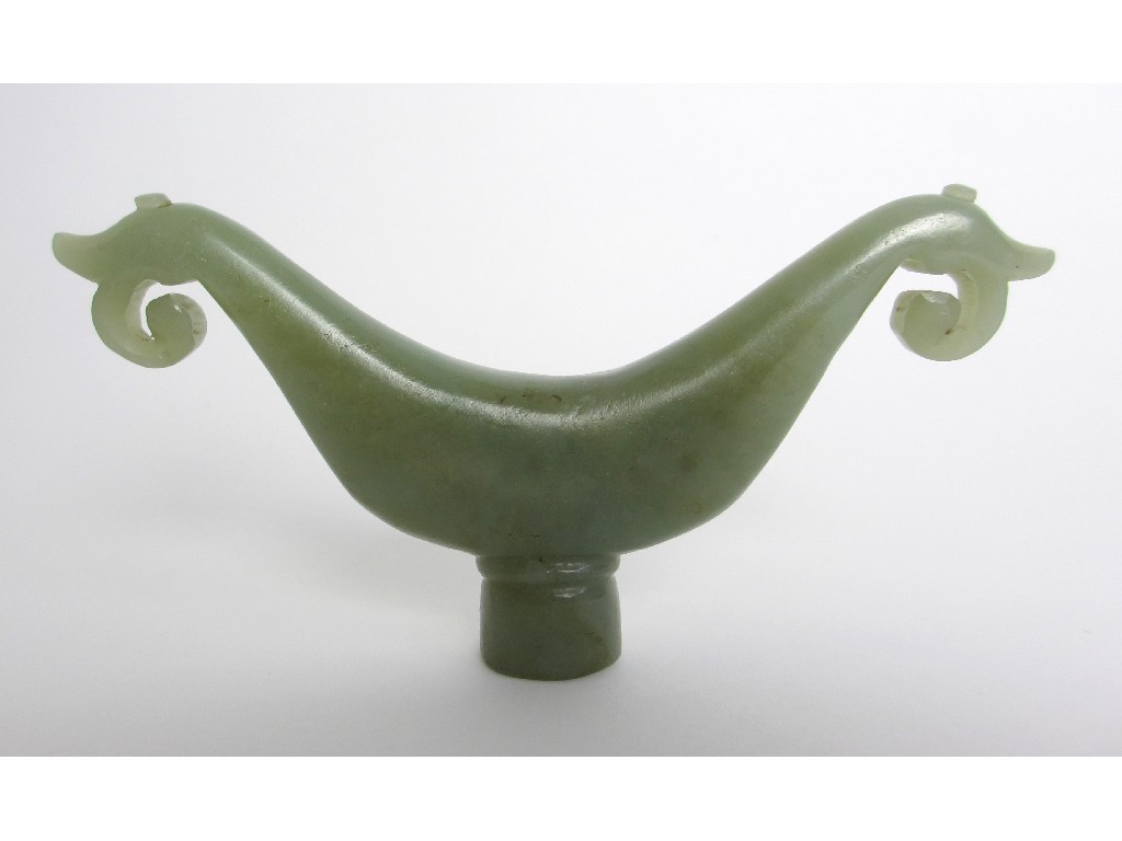 Appraisal: A Chinese jade scroll shaped rest with pierced foliate ends