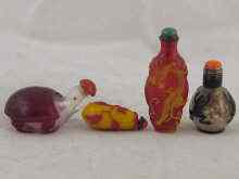 Appraisal: Four Chinese glass overlay snuff bottles one as a tortoise