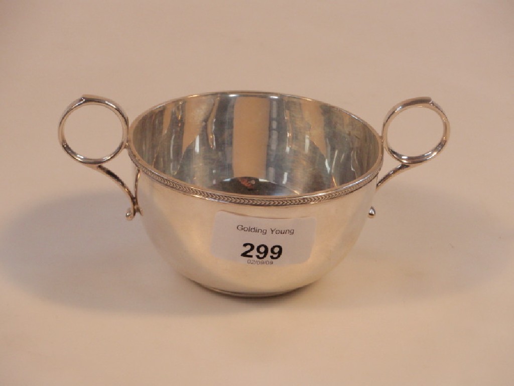 Appraisal: A silver two handled dish with ring handles and herringbone