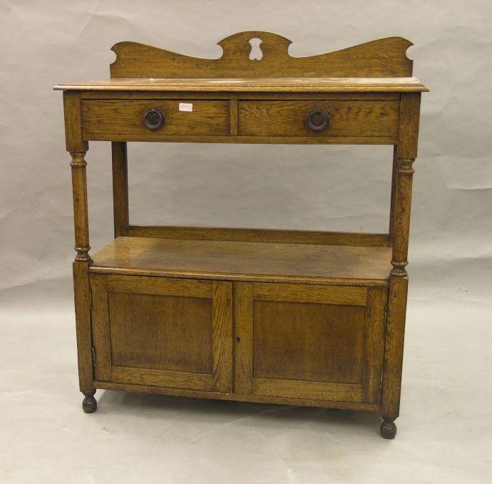 Appraisal: A late Victorian solid medium oak buffet with carved cresting