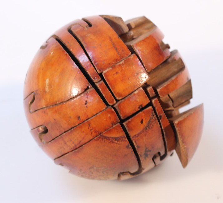 Appraisal: A most unusual polished treen puzzle ball the orb cut