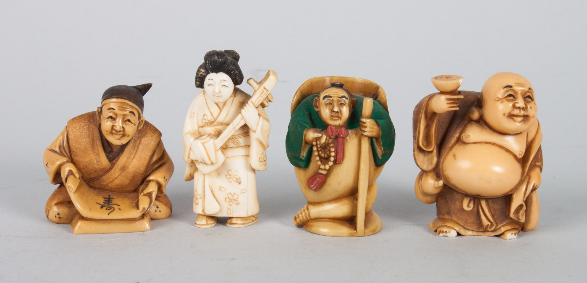 Appraisal: Four Japanese carved ivory netsukes with polychrome and ink highlights