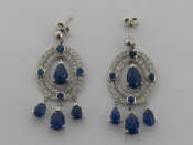 Appraisal: A pair of sapphire and diamond pendant earrings the central