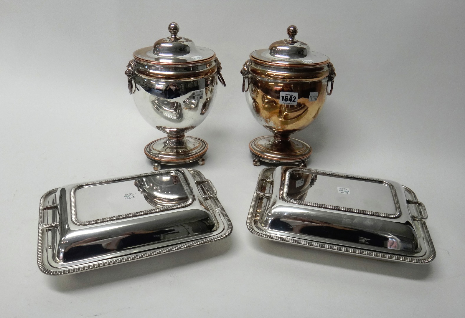 Appraisal: A pair of plated on copper twin handled lidded urns