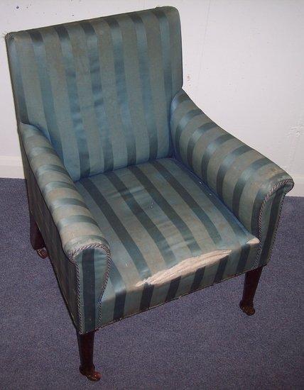 Appraisal: A late Victorian upholstered armchair on turned legs with ceramic