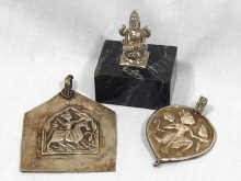 Appraisal: A mixed lot comprising two silver pendants depicting Indian gods