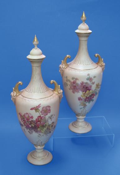 Appraisal: A PAIR OF ROYAL WORCESTER BLUSH IVORY VASES AND COVERS