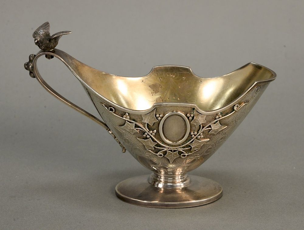 Appraisal: Sterling silver creamer with bird mounted handle and gold washed