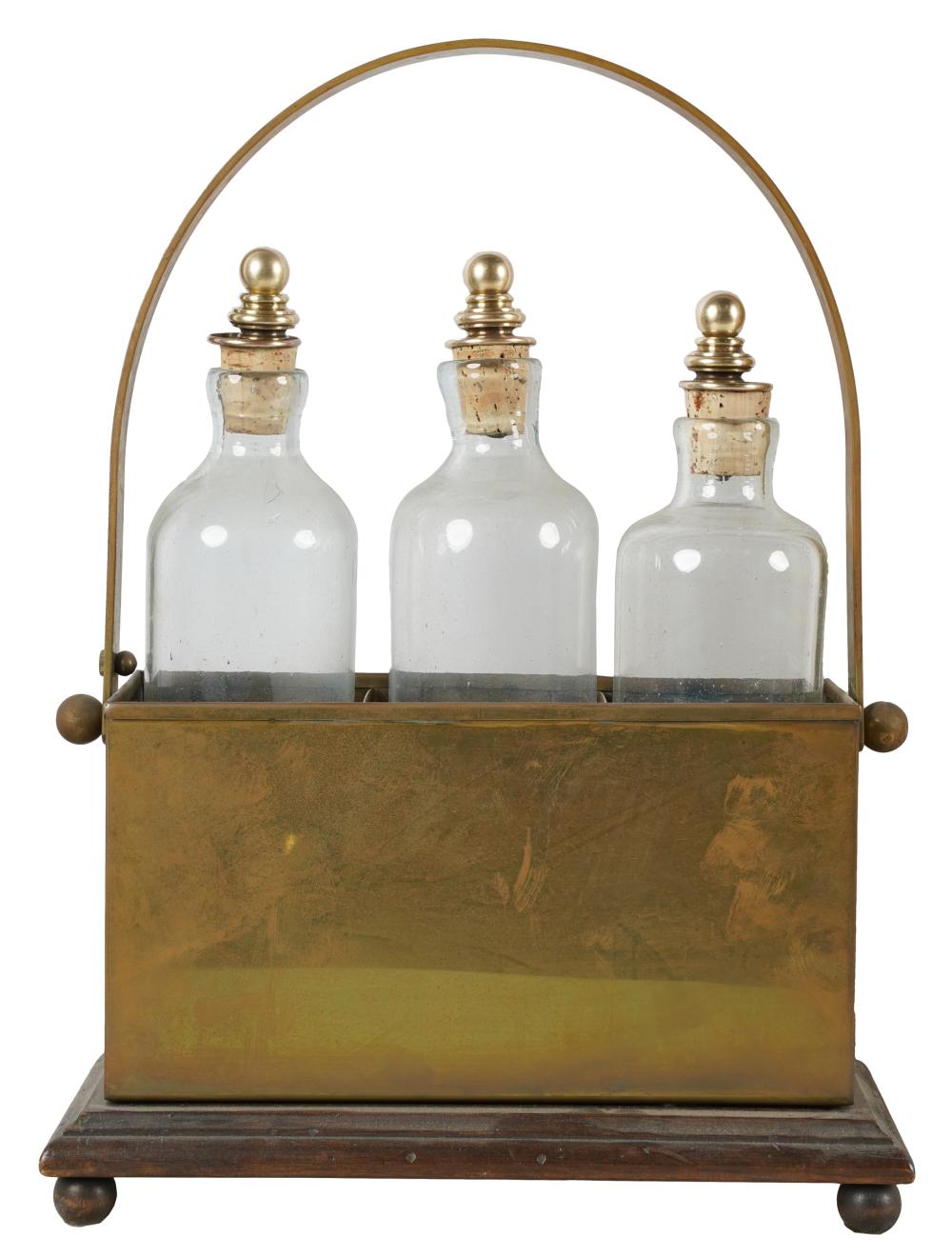 Appraisal: ENGLISH BRASS WOOD TANTALUSwith three glass bottles with brass and