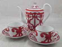 Appraisal: A Hermes teapot with two cups and saucers the cylindrical