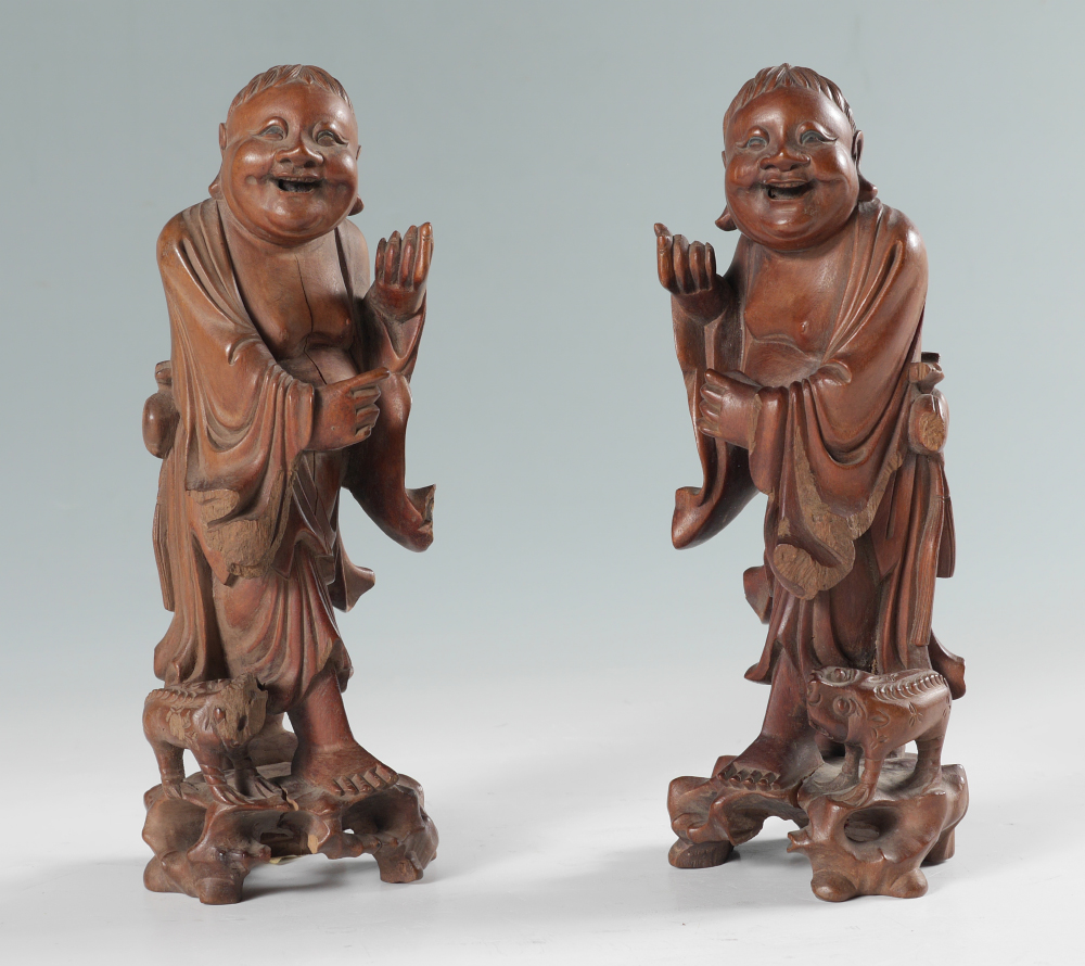 Appraisal: PAIR JAPANESE CARVED WOOD FIGURES Mirror image pair of smiling