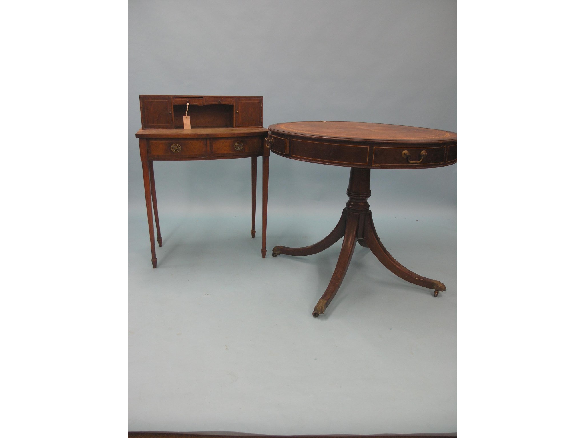 Appraisal: A reproduction mahogany centre table inset leather circular top with