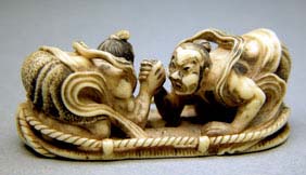 Appraisal: IVORY NETSUKE BY KEI-UN Elaborately carved ivory netsuke of two