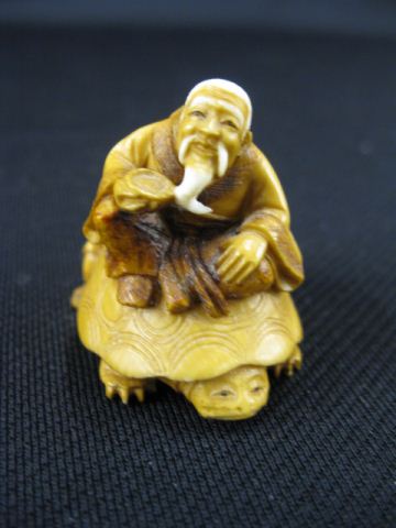 Appraisal: Carved Ivory Netsuke of a Bearded Manand young boy on