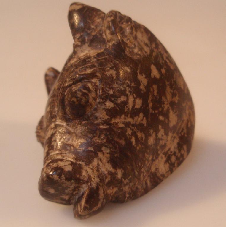 Appraisal: A small purple porphyry statuette of a bovine head possibly