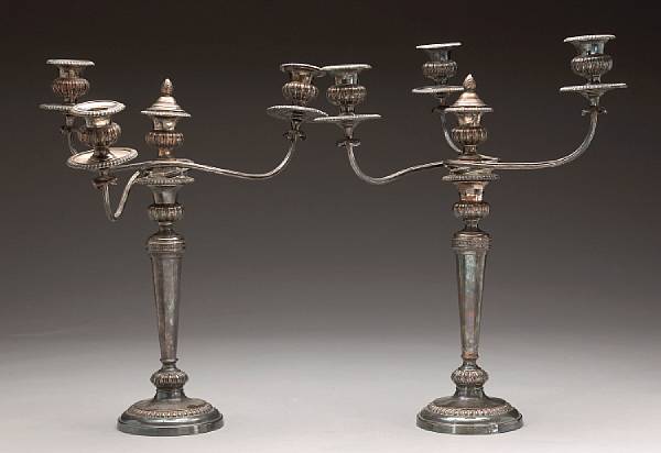 Appraisal: A Sheffield plate pair of candlesticks with matching three arm-four