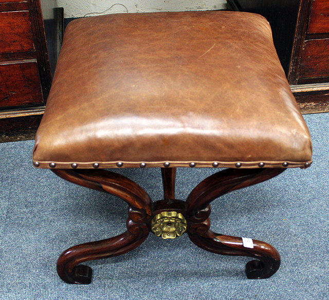 Appraisal: A ROSEWOOD X-FRAMED STOOL with brown leather upholstered seat and