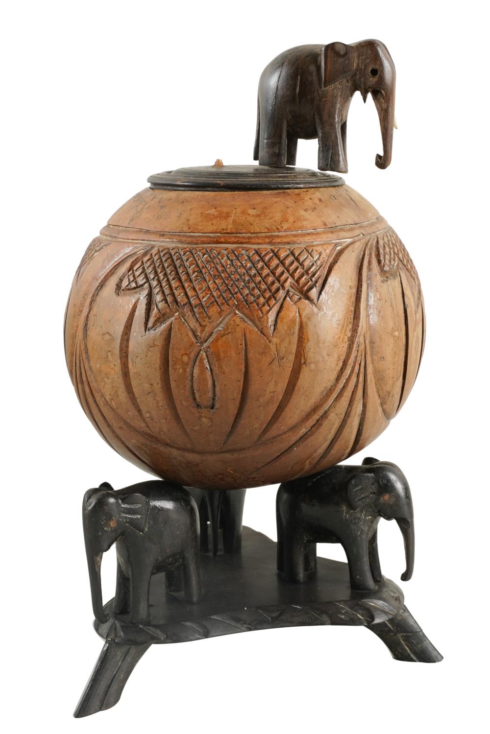 Appraisal: CARVED COCONUT ON CARVED WOOD ELEPHANT BASEwith carved wood cover