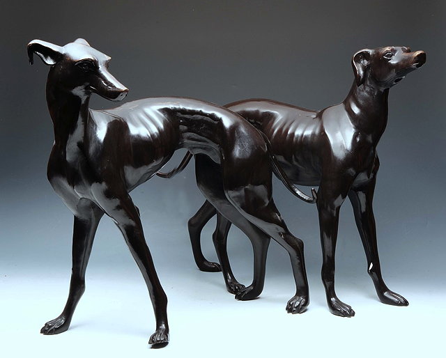 Appraisal: A PAIR OF BRONZE MODELS of whippets standing in an