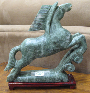 Appraisal: PAIR OF CHINESE GREEN SOAPSTONE EQUESTRIAN FIGURES BOOKENDS the prancing