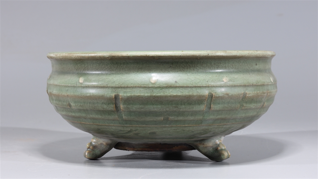 Appraisal: Chinese celadon glazed porcelain tripod censer with molded designs and