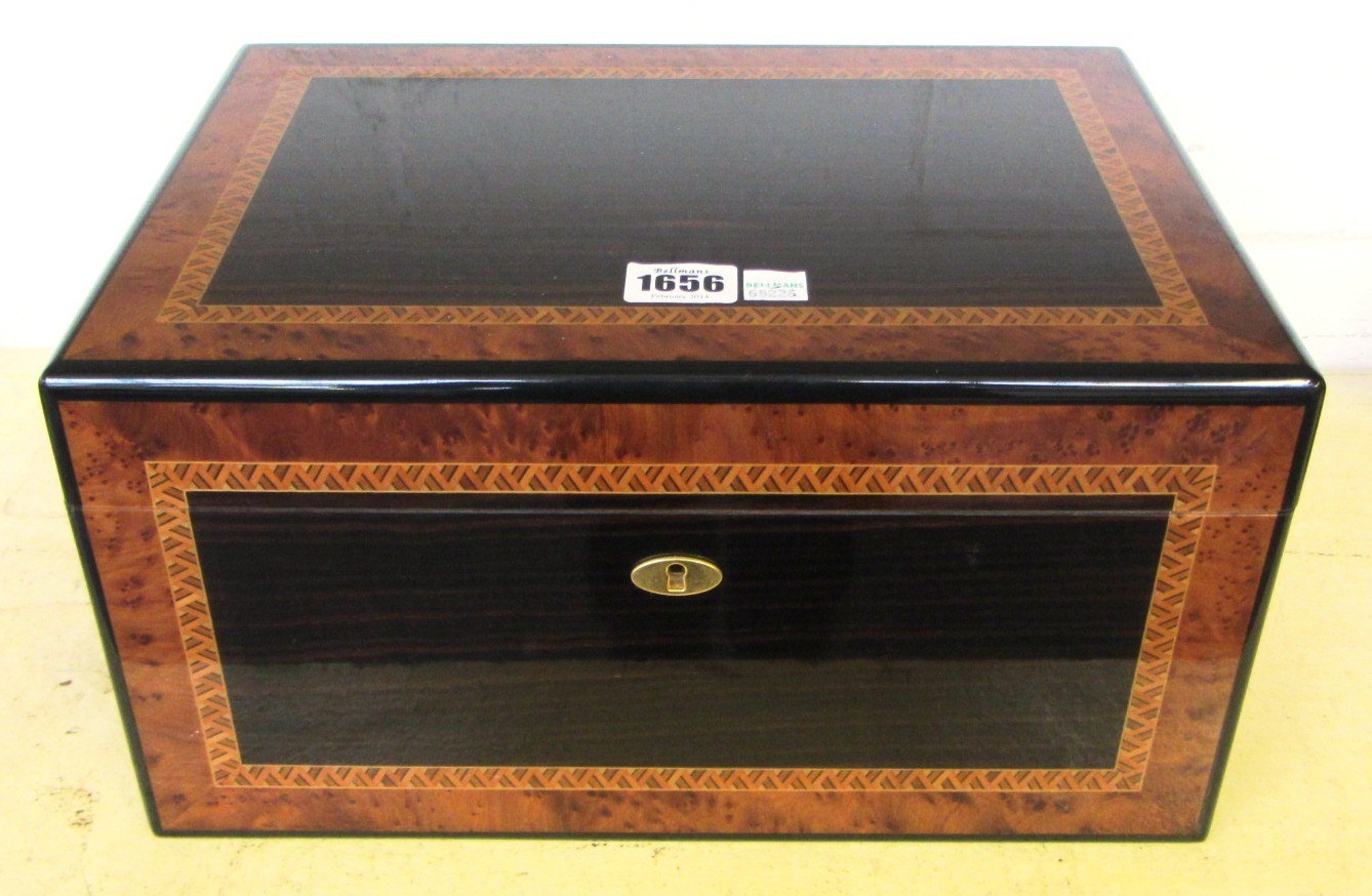 Appraisal: A Dunhill macassar ebony and burr yew humidor dated LTD