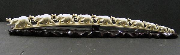 Appraisal: An ivory tusk carving of an elephant bridge Each of