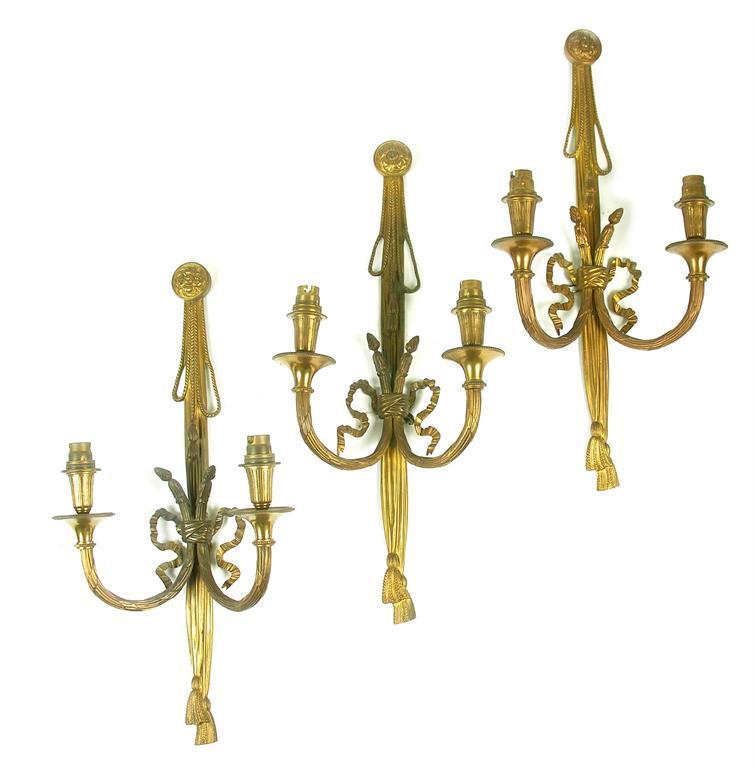 Appraisal: A set of three gilt brass two branch wall lights