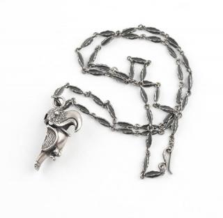 Appraisal: A silver parrot pendant with carved silver chain Indicipherable stamp