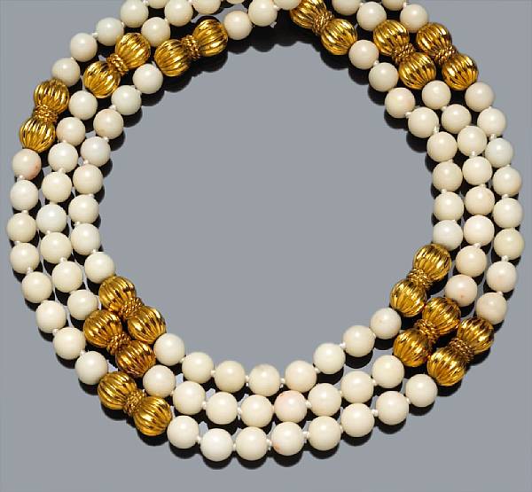 Appraisal: A coral bead and fourteen karat gold three-strand necklace white