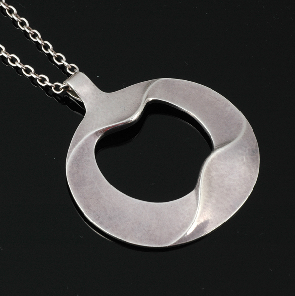 Appraisal: A GEORG JENSEN SILVER PENDANT AND CHAIN Modelled in sterling