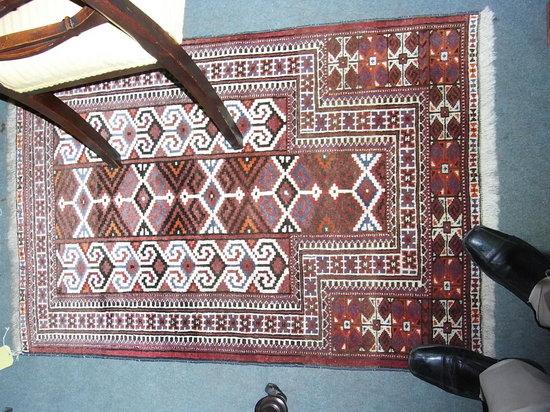 Appraisal: A HANDMADE BOKHARA TYPE RUG with central geometric panels and