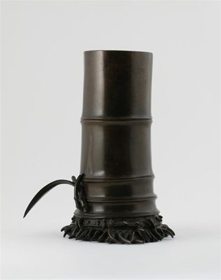 Appraisal: A Japanese bronze vase formed as a large section of