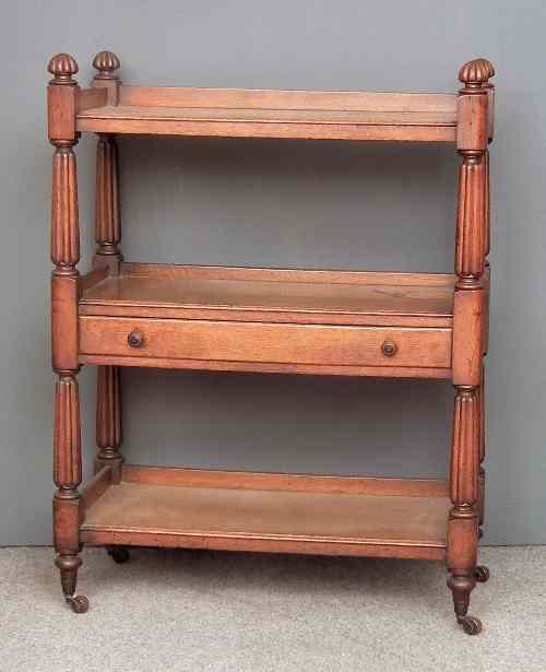 Appraisal: A Victorian oak three tier tray top dinner wagon fitted